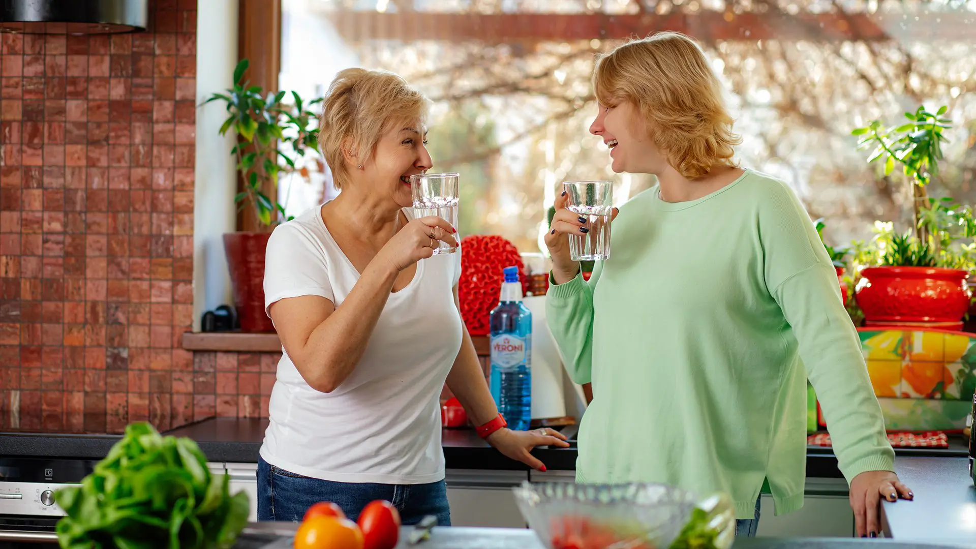 senior and her loved one drinking water to stay hydrated