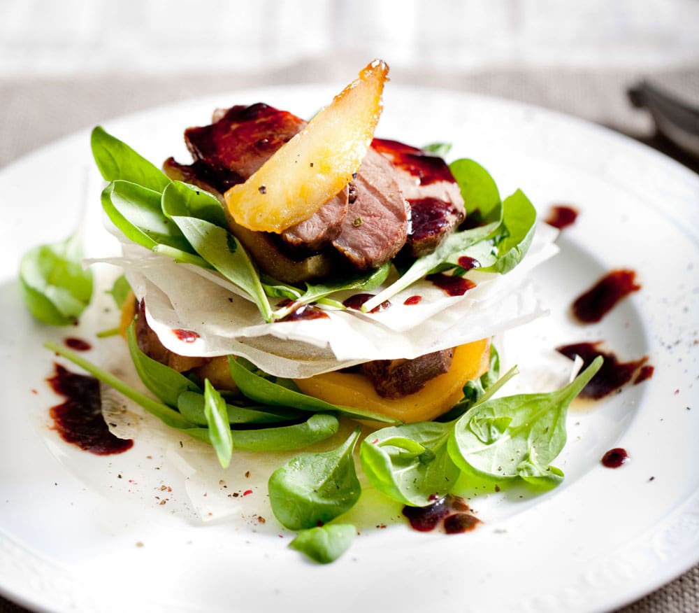 Closeup of a gourmet meal presented on a white dish 