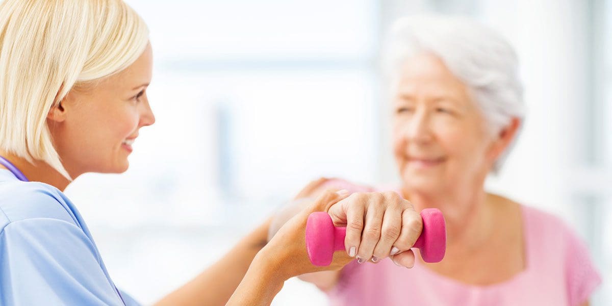 Senior woman working with a physical therapist