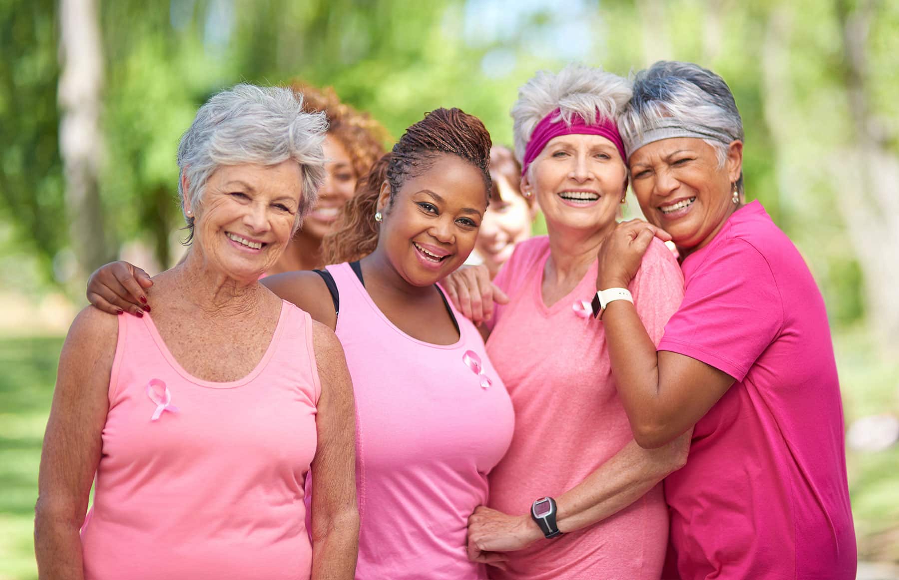 group of senior women wearing oink breast cancer awareness shirts
