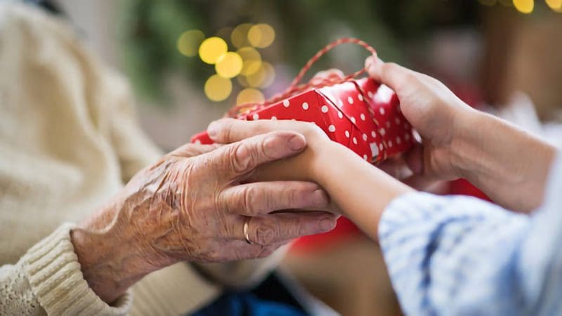 senior aged hands exchanging gifts