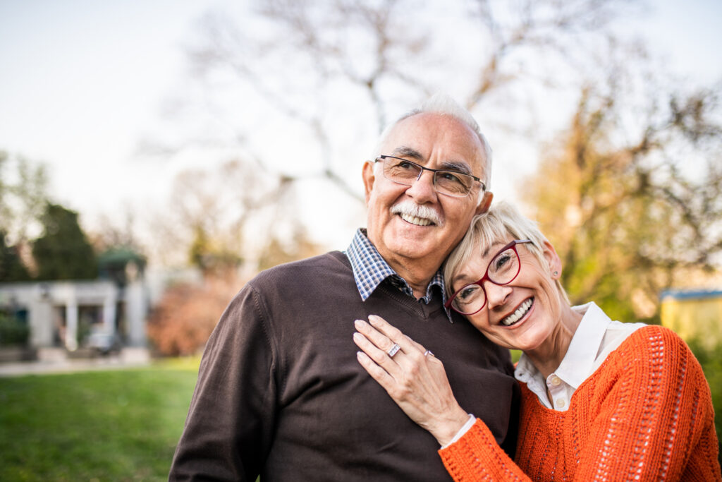 senior couple smiling outside