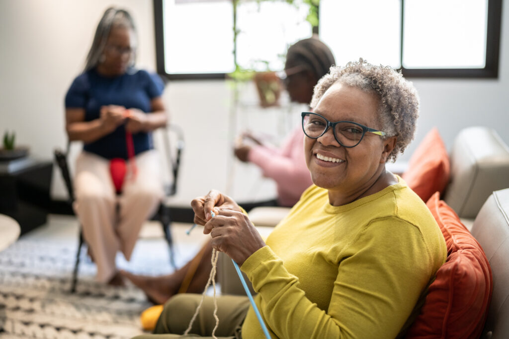 Senior woman smiling at knitting club